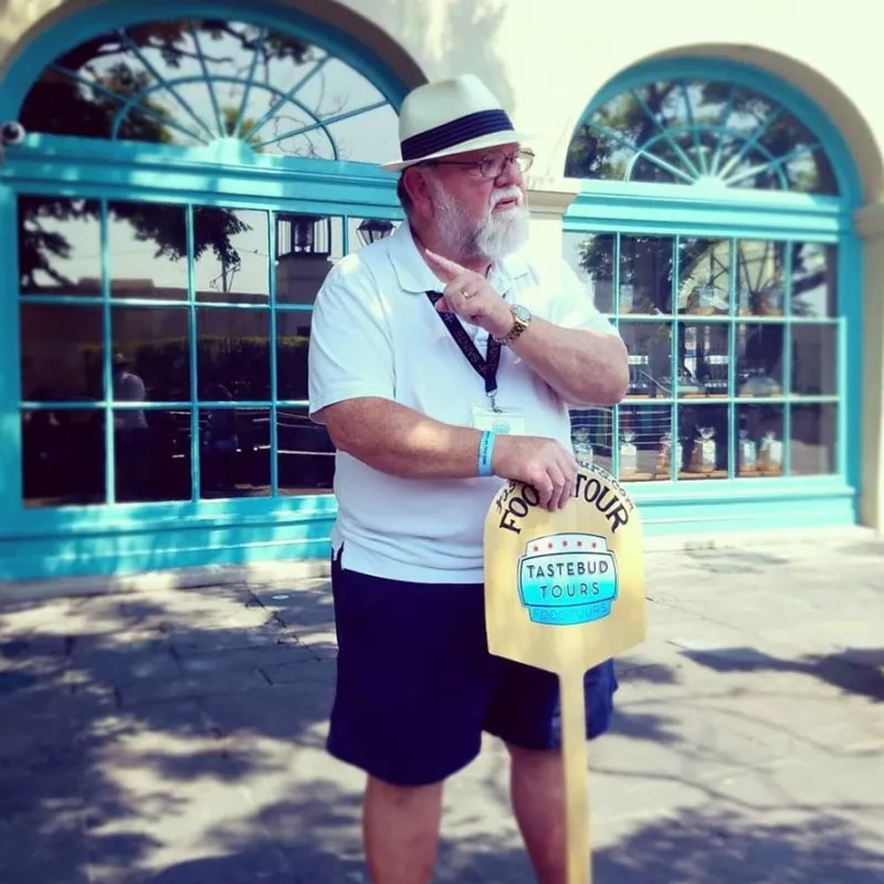 Man Holding Tastebud Tours Board