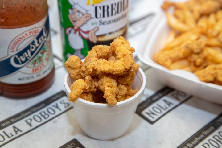 a bottle next to a pile of fries