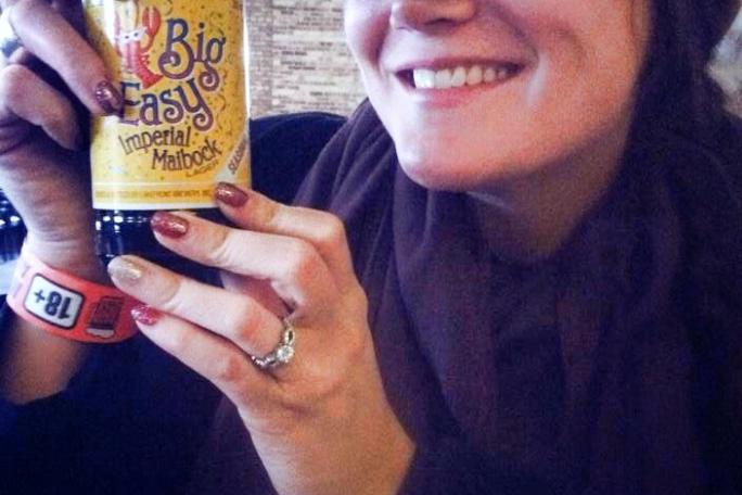 a person wearing a hat and smiling at the camera