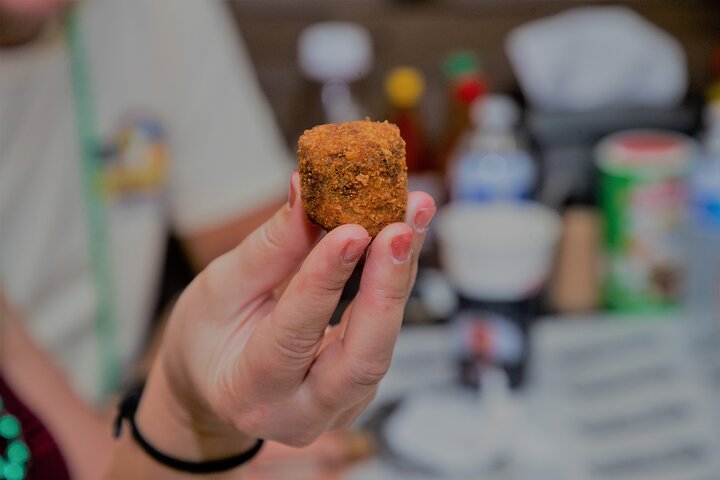 a hand holding a piece of cake