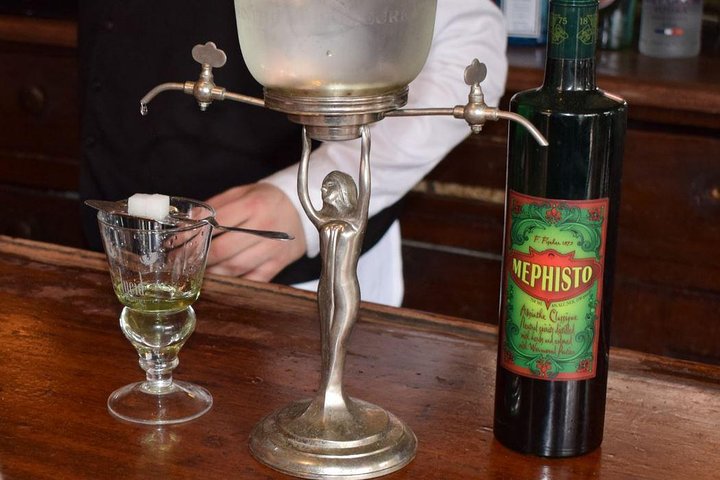 a glass of wine sitting on top of a wooden table