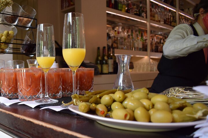a plate of food and glasses of wine on a table
