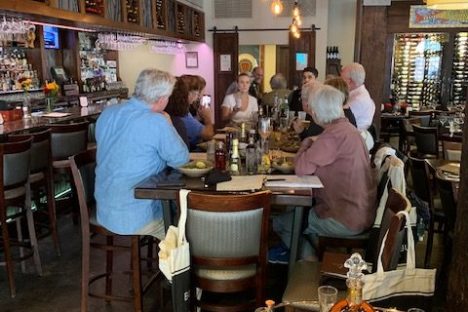 a group of people sitting at a table in a restaurant