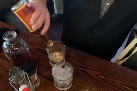 a person sitting at a table with wine glasses