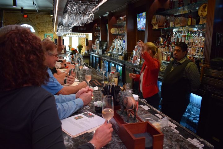 a group of people sitting at a table with wine glasses