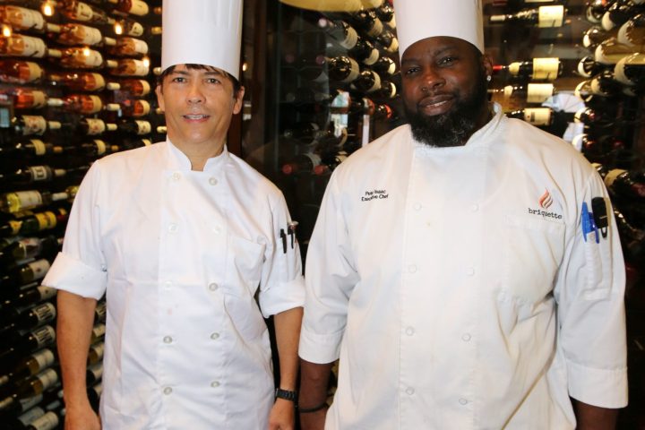 a man standing in front of Santiago J. Erevia et al. posing for the camera