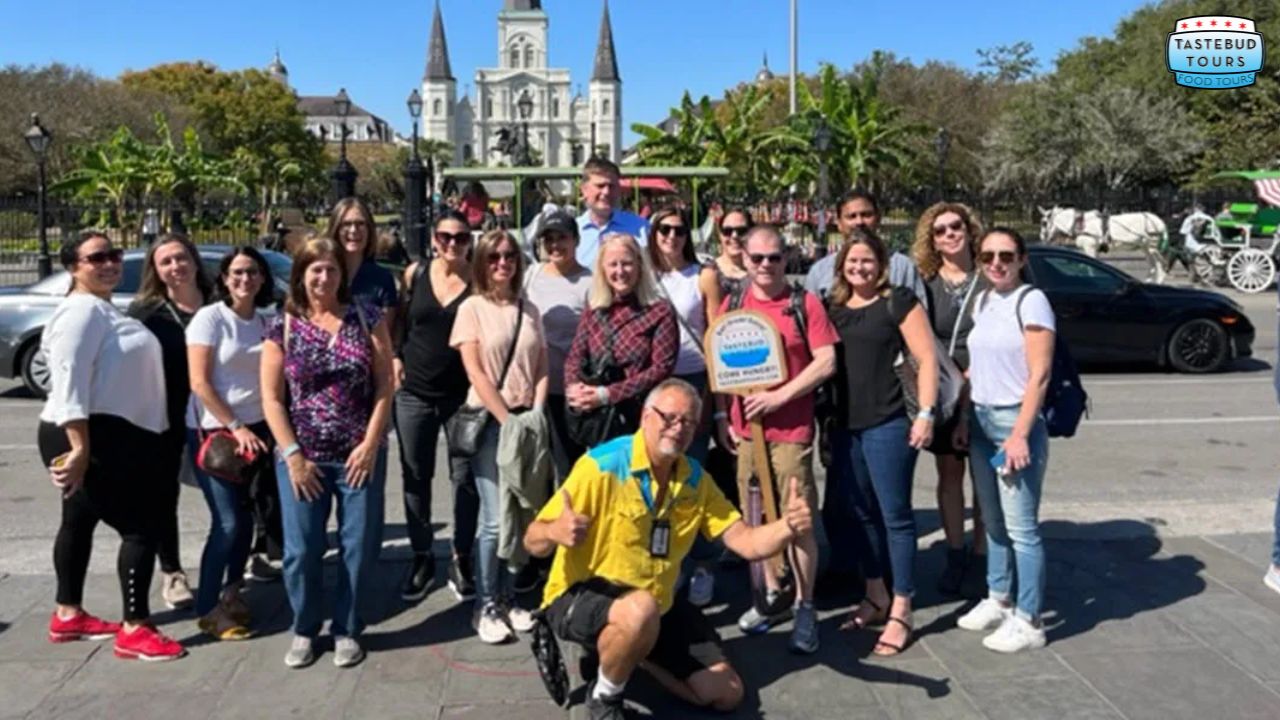 private-food-tours-in-new-orleans (1) a group of people standing in front of a crowd posing for the camera