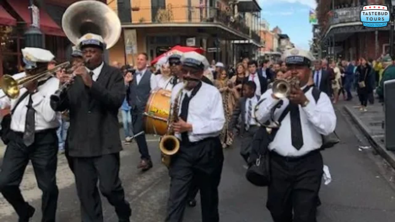 Brass band leading a parade through a lively city street.