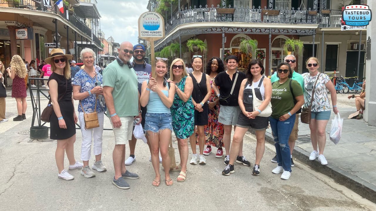 Group of people posing on a street corner in a historic city.