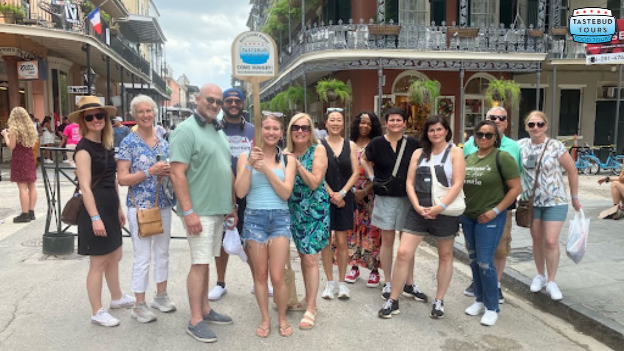 Group of people posing on a street with historic buildings in the background.