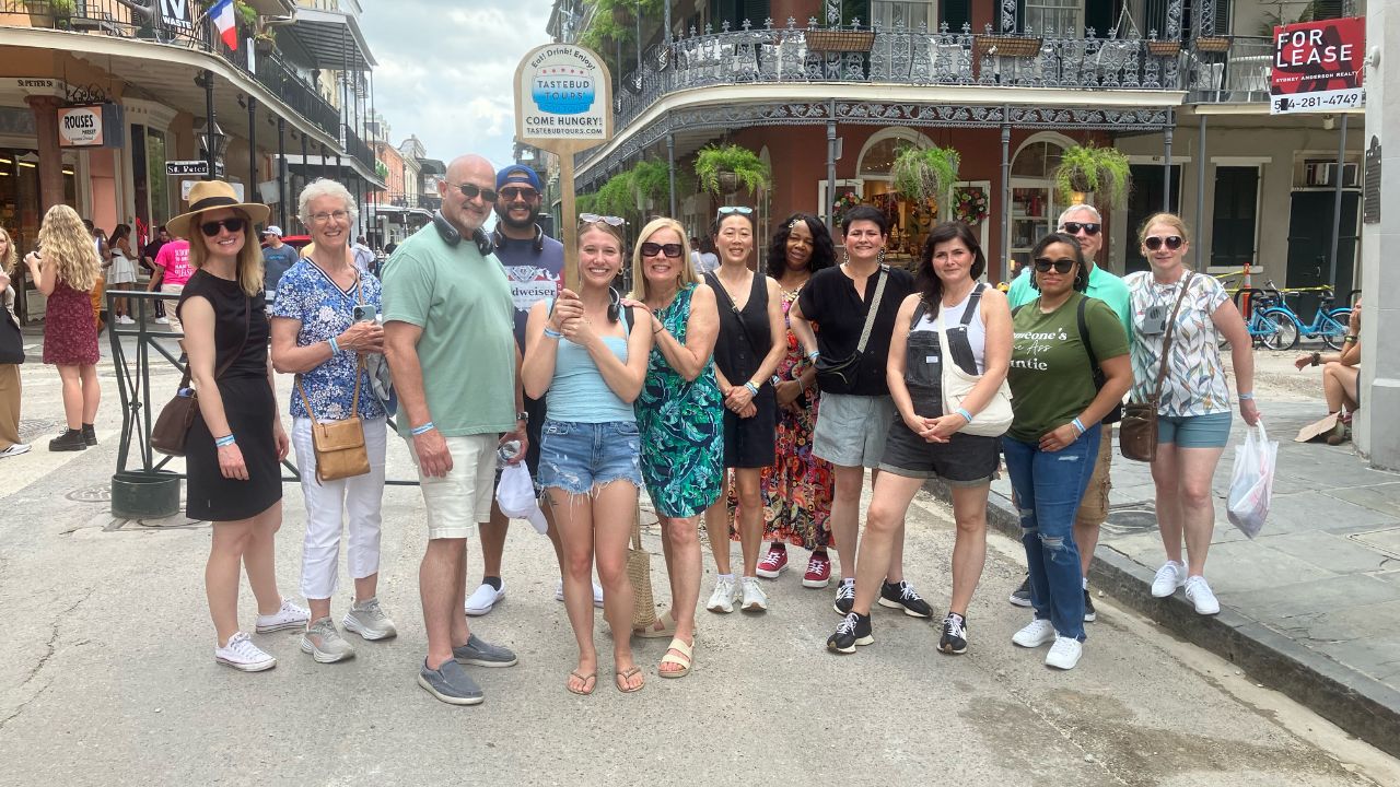 A group on a food tour discovering the flavors of New Orleans in July. 