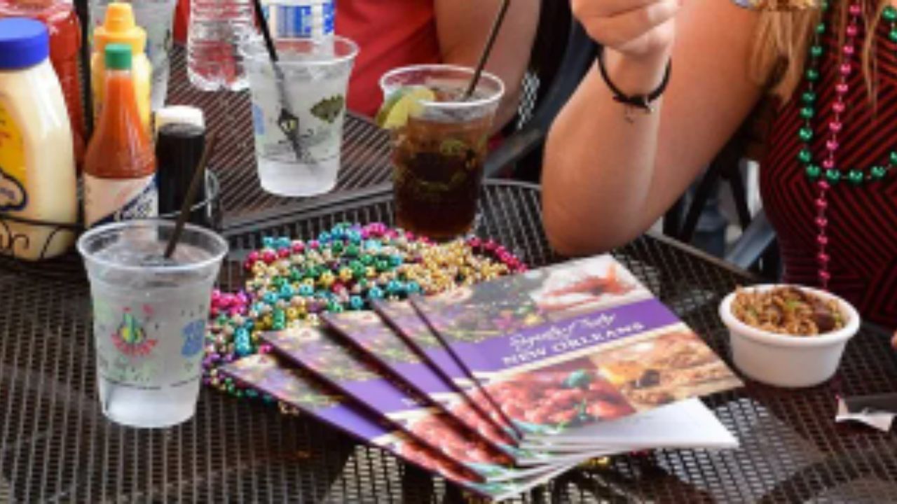 A group of people gathered around a table enjoying drinks and food together  as part of Tastebud Food Tours experience.