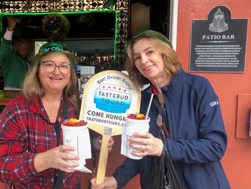 Visitors walking through a historic New Orleans neighborhood during a food tour.