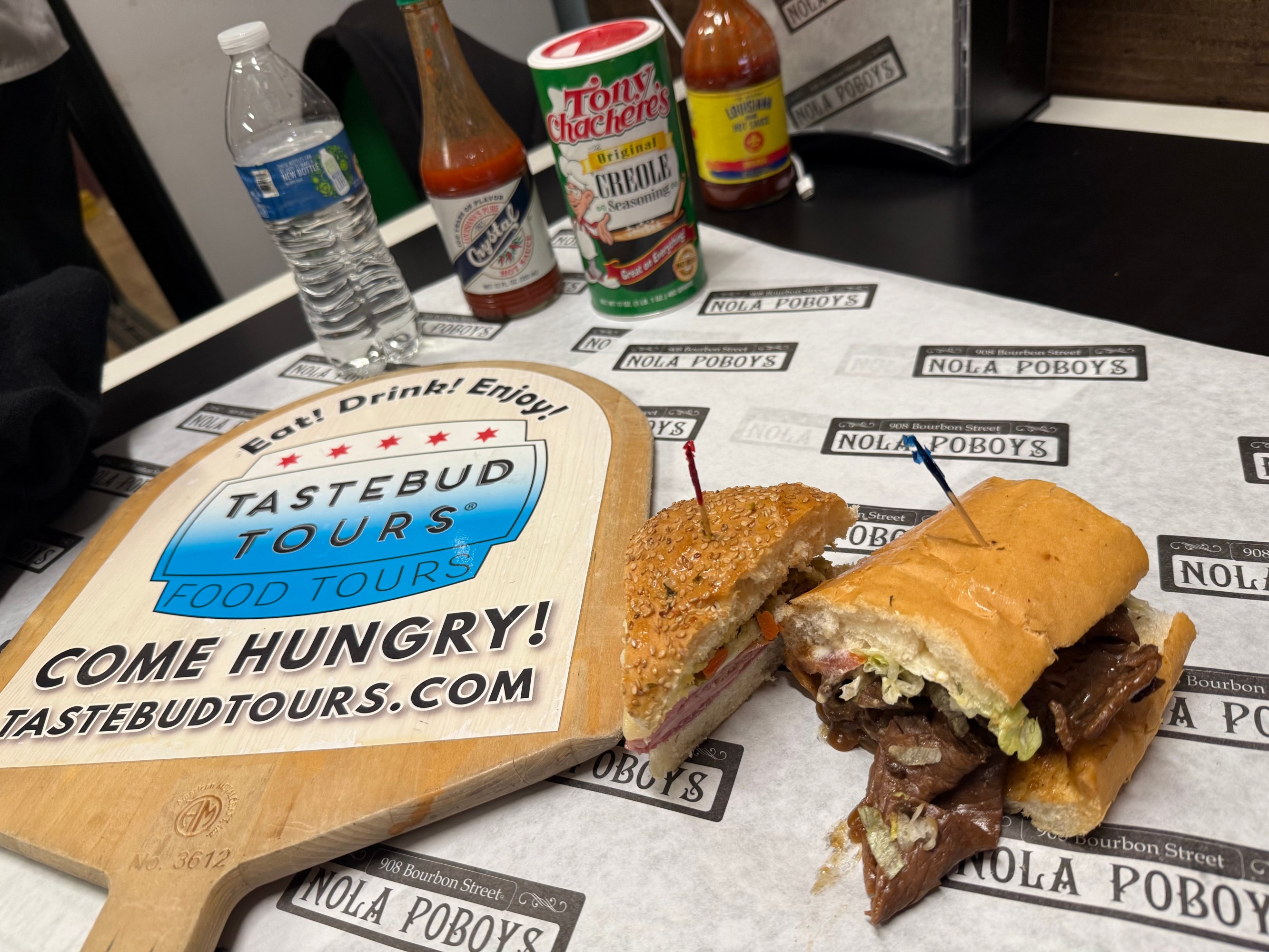 A spread of iconic local dishes on a table in New Orleans during a guided food tour.
