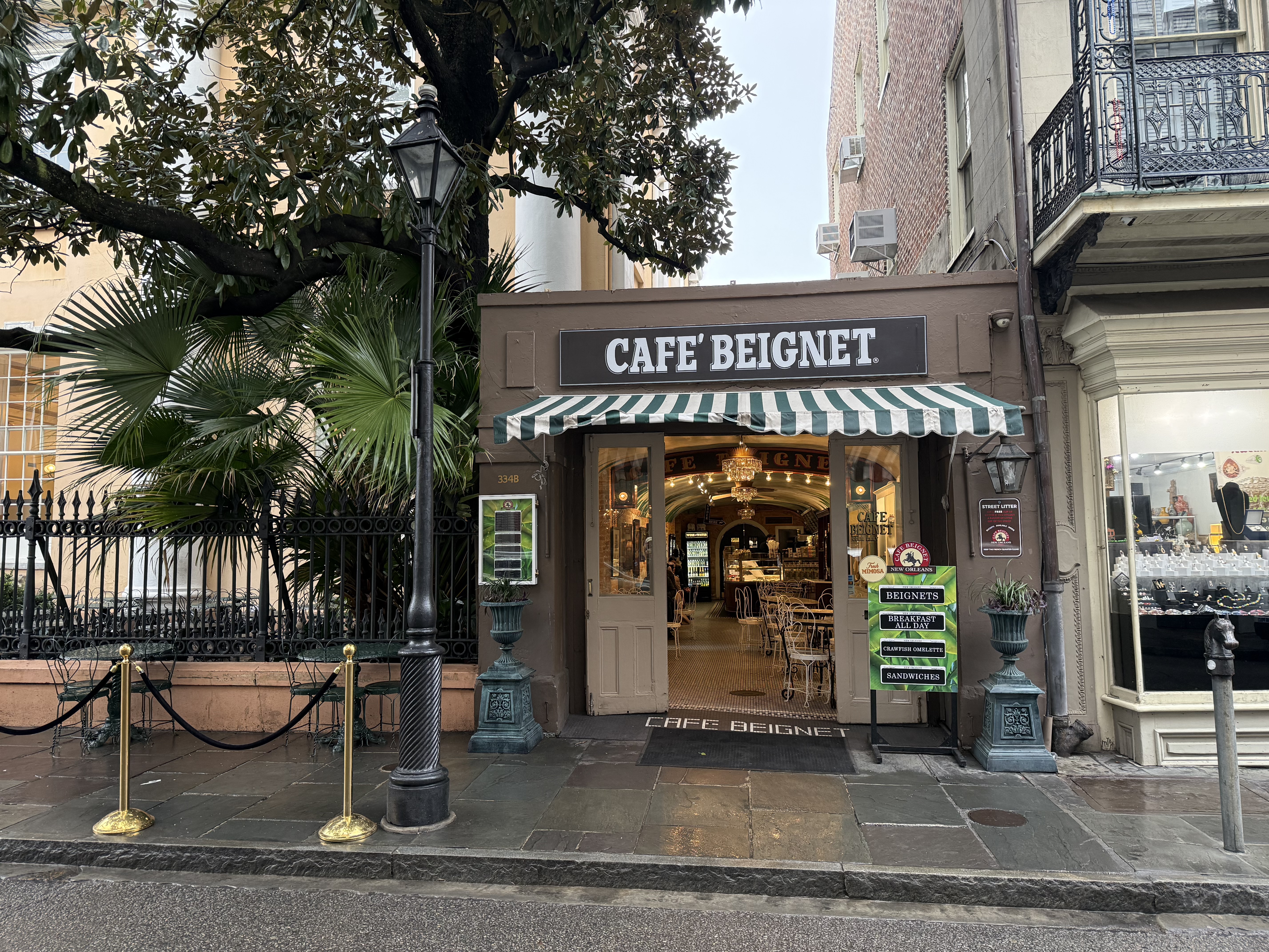 Café Beignet entrance in New Orleans French Quarter, a popular stop for families.
