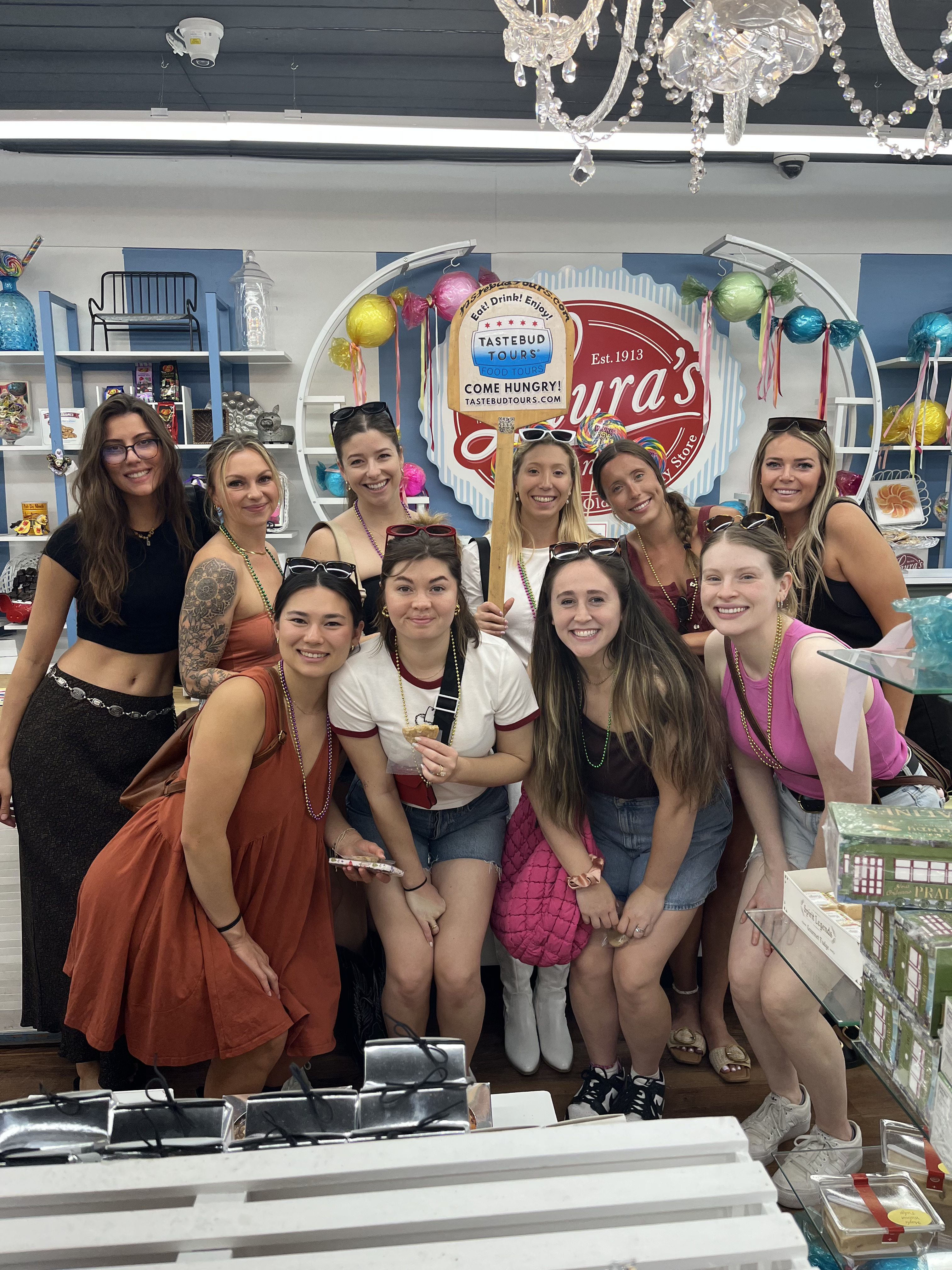 Friends walking through New Orleans’ famous sweet shops on a guided progressive dinner food tour. 