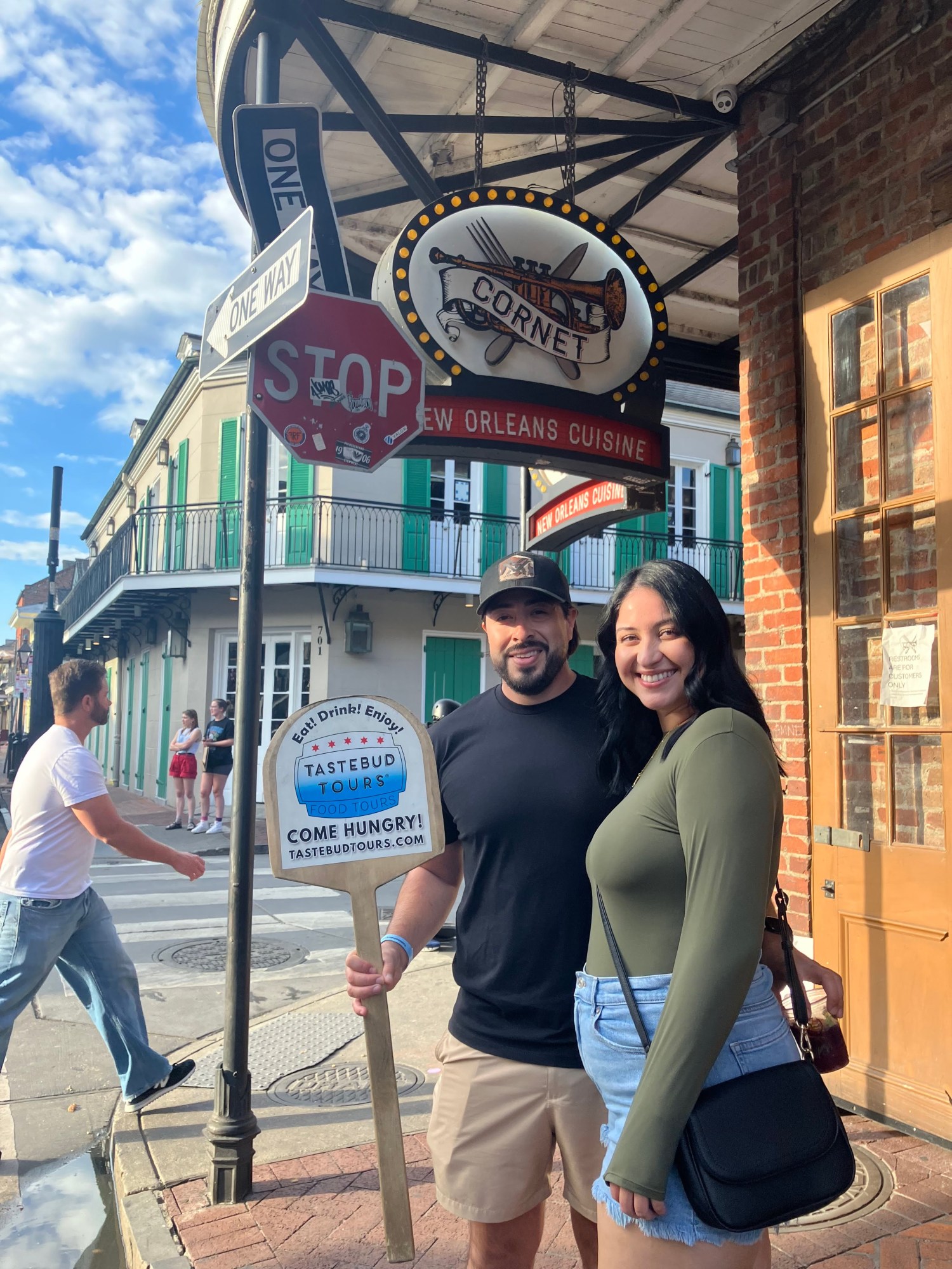 Couple exploring the French Quarter on a romantic New Orleans walking food tour during their honeymoon.