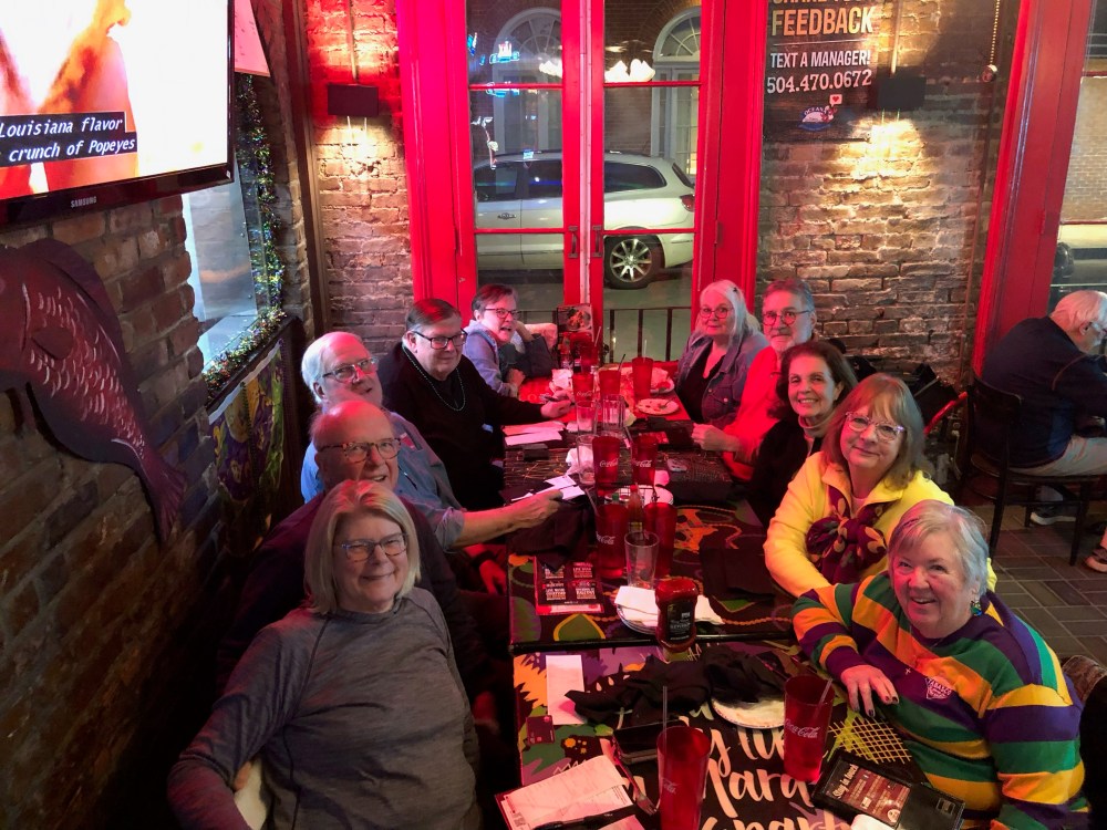 Guests enjoying food and drinks on a New Orleans food tour.
