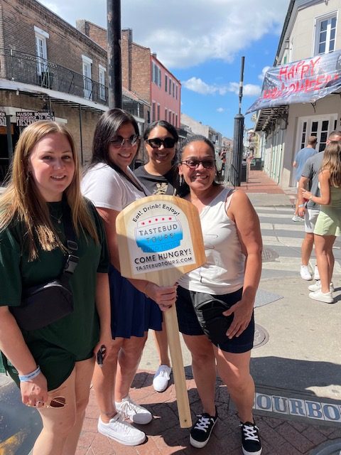 Guests posing during a guided walking food tour through the New Orleans French Quarter.