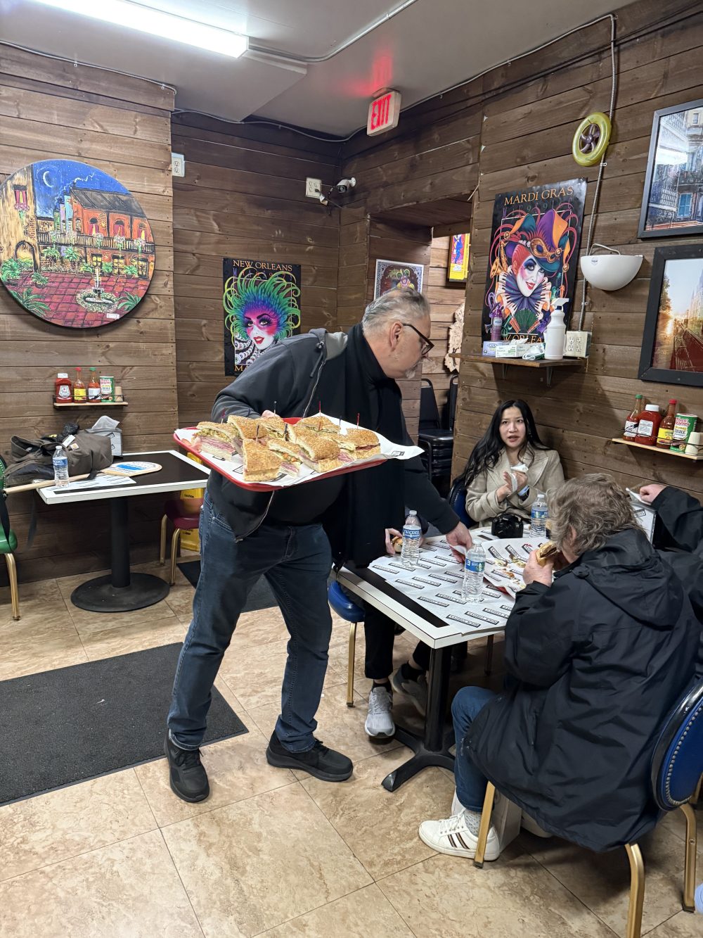 Server bringing po’boys to guests at a New Orleans restaurant.