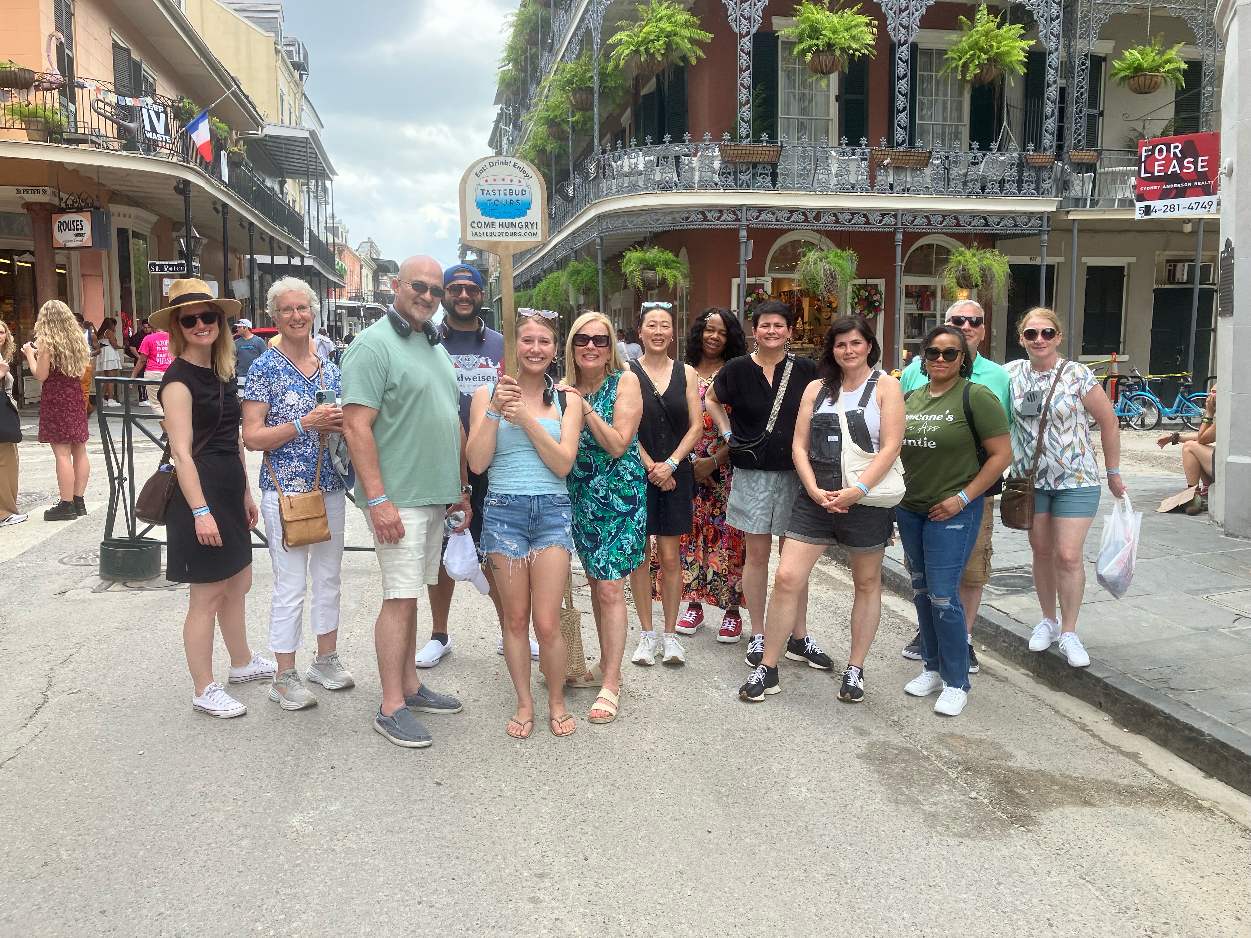 Tourist wearing comfortable walking shoes and carrying an umbrella while exploring New Orleans streets in humid weather.
