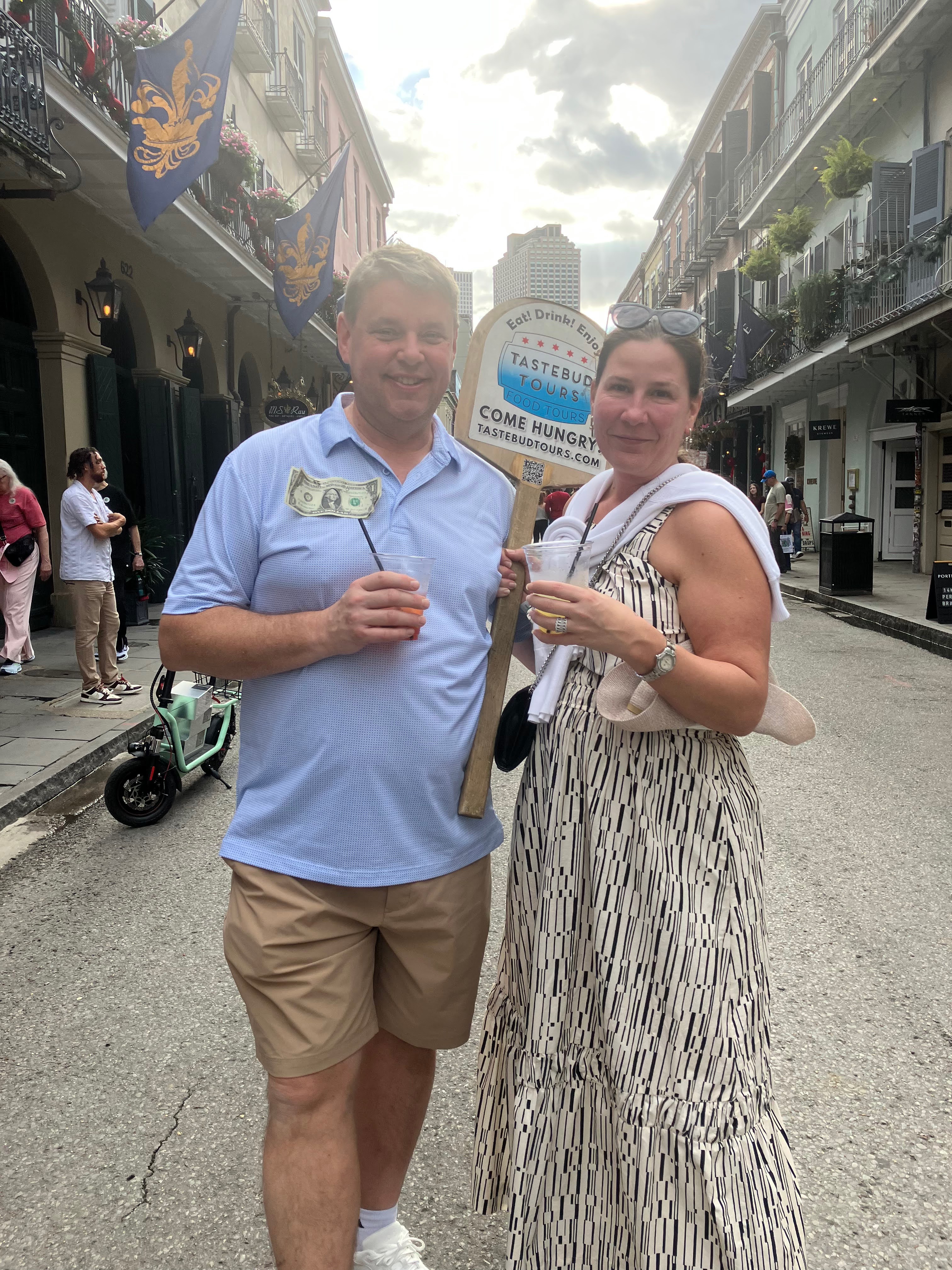 Traveler on a New Orleans food tour, tasting local drinks.