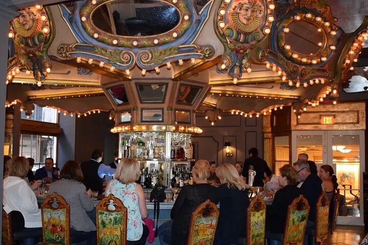 Guests gathered around an ornate circular bar during a New Orleans cocktail tour.
