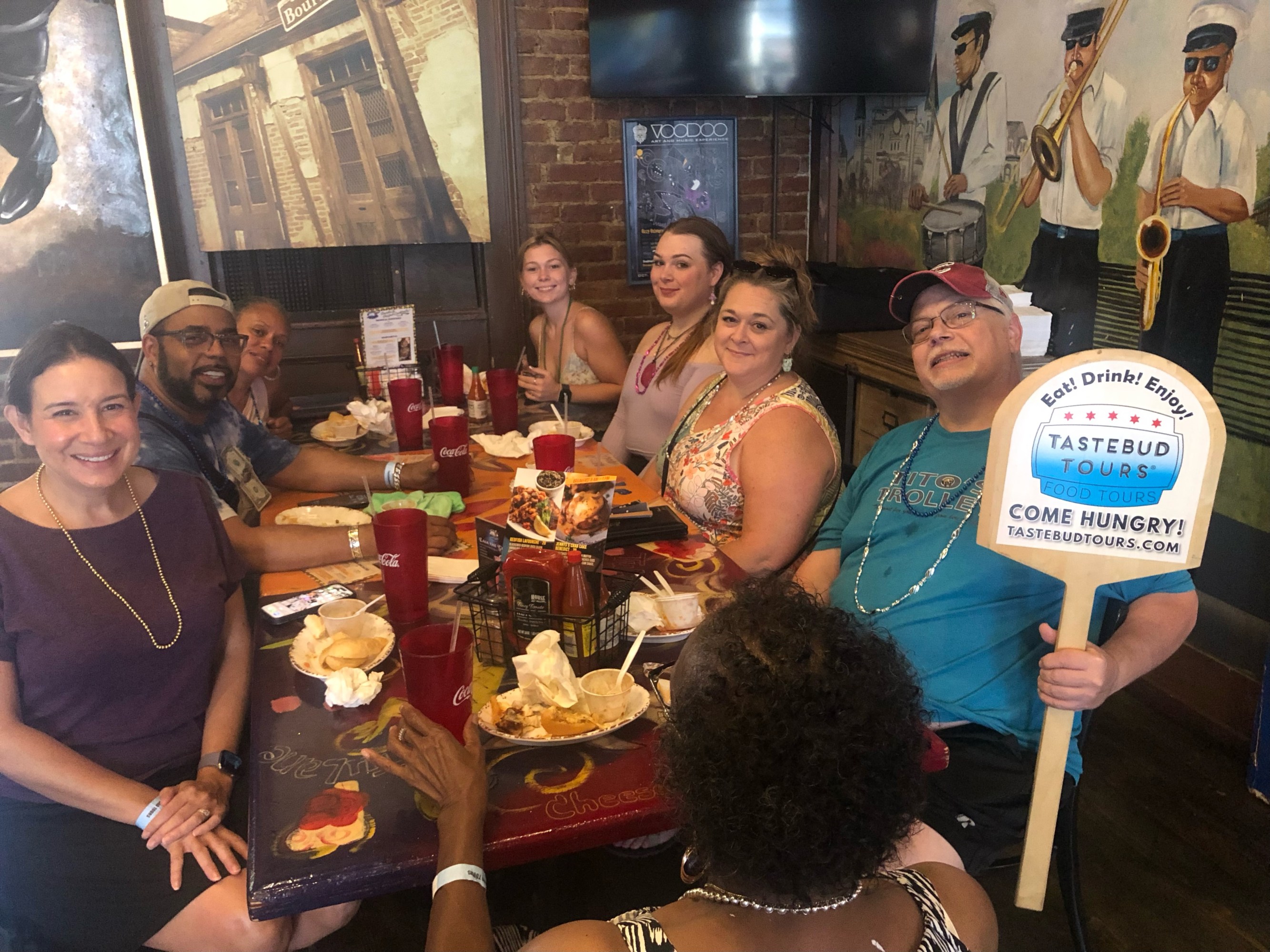 Food tour guests sharing a meal inside New Orleans restaurant.
