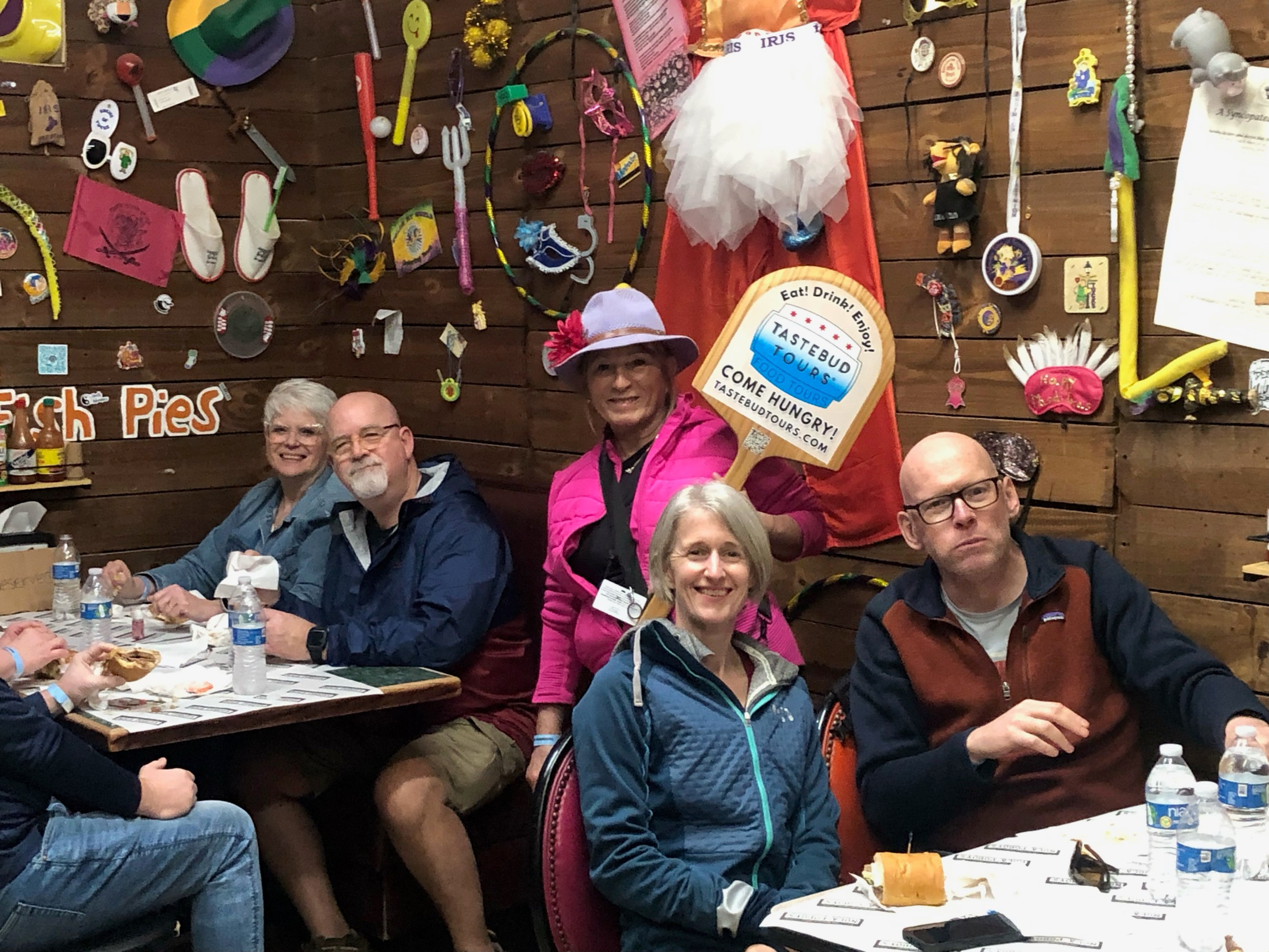 Tastebud Tours guests enjoying food inside a decorated New Orleans restaurant.