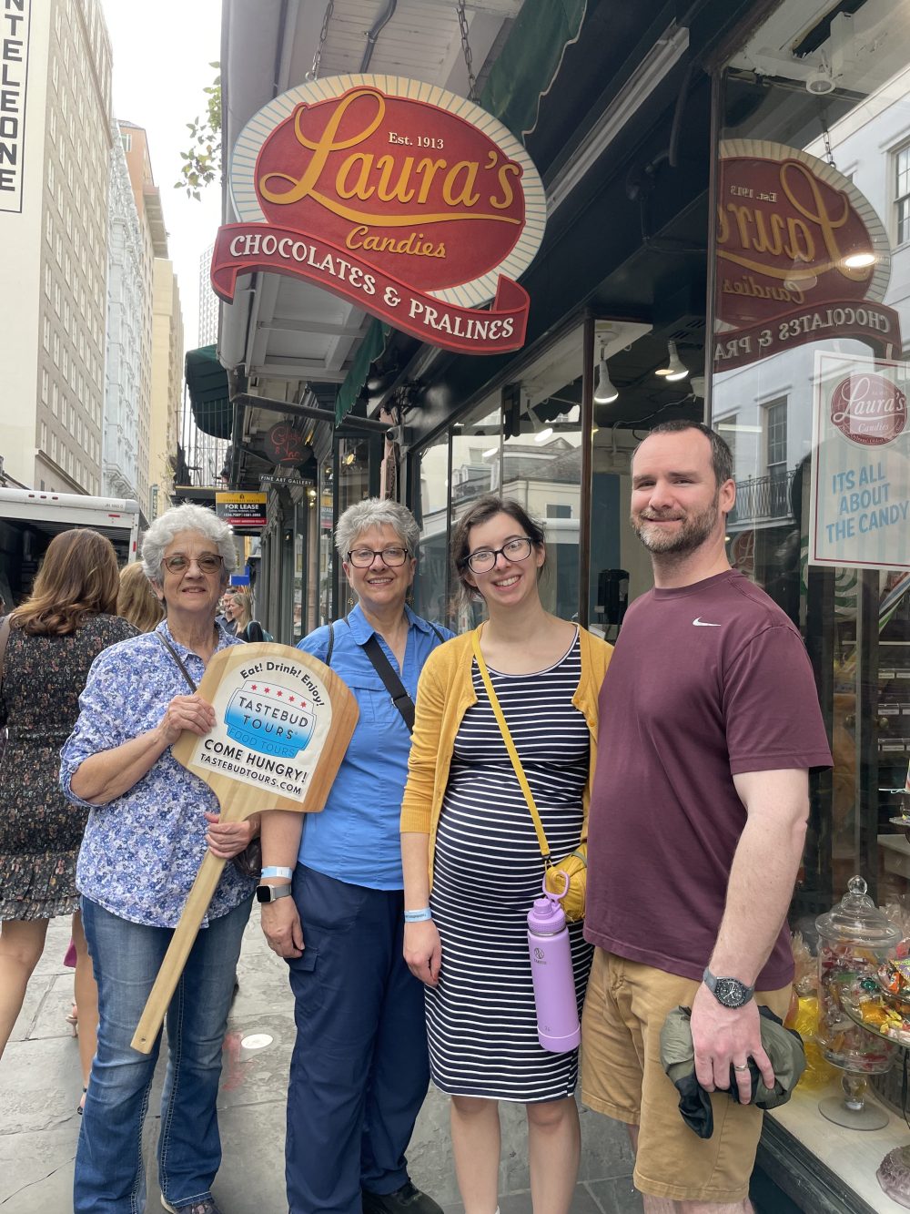 Tastebud Tours guests pose outside Laura’s Candies in the French Quarter.