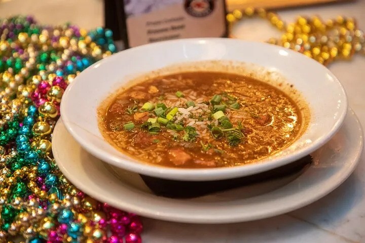 Bowl of New Orleans seafood gumbo with rice and green onions, a classic Louisiana cuisine favorite
