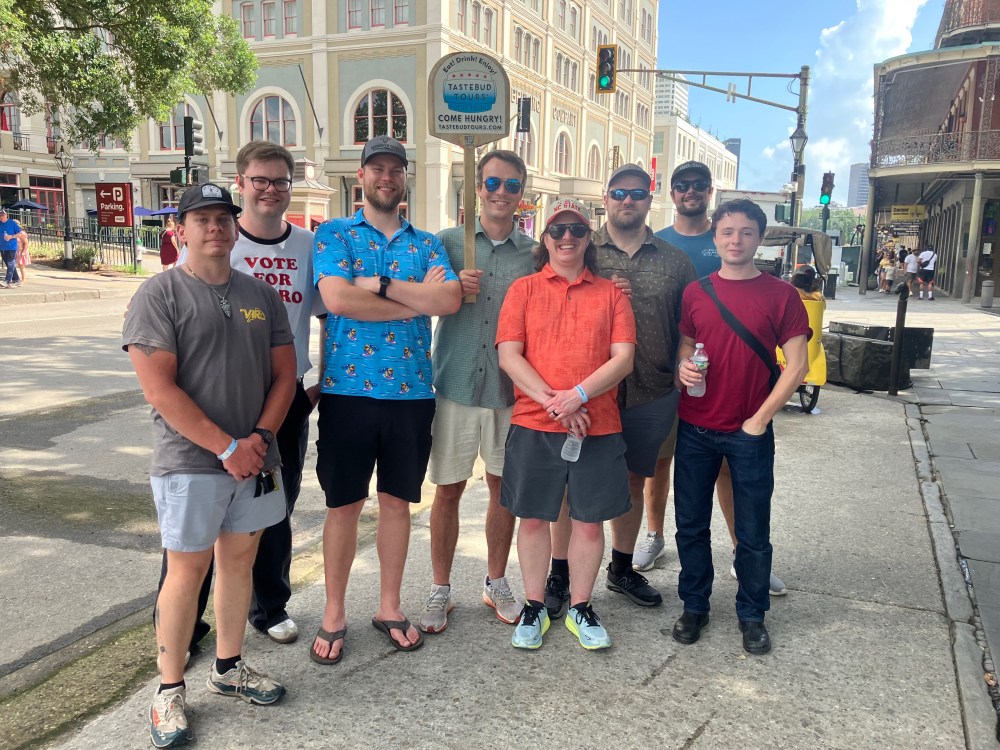 Group of guests enjoying a Tastebud Tours walking food tour in New Orleans French Quarter.