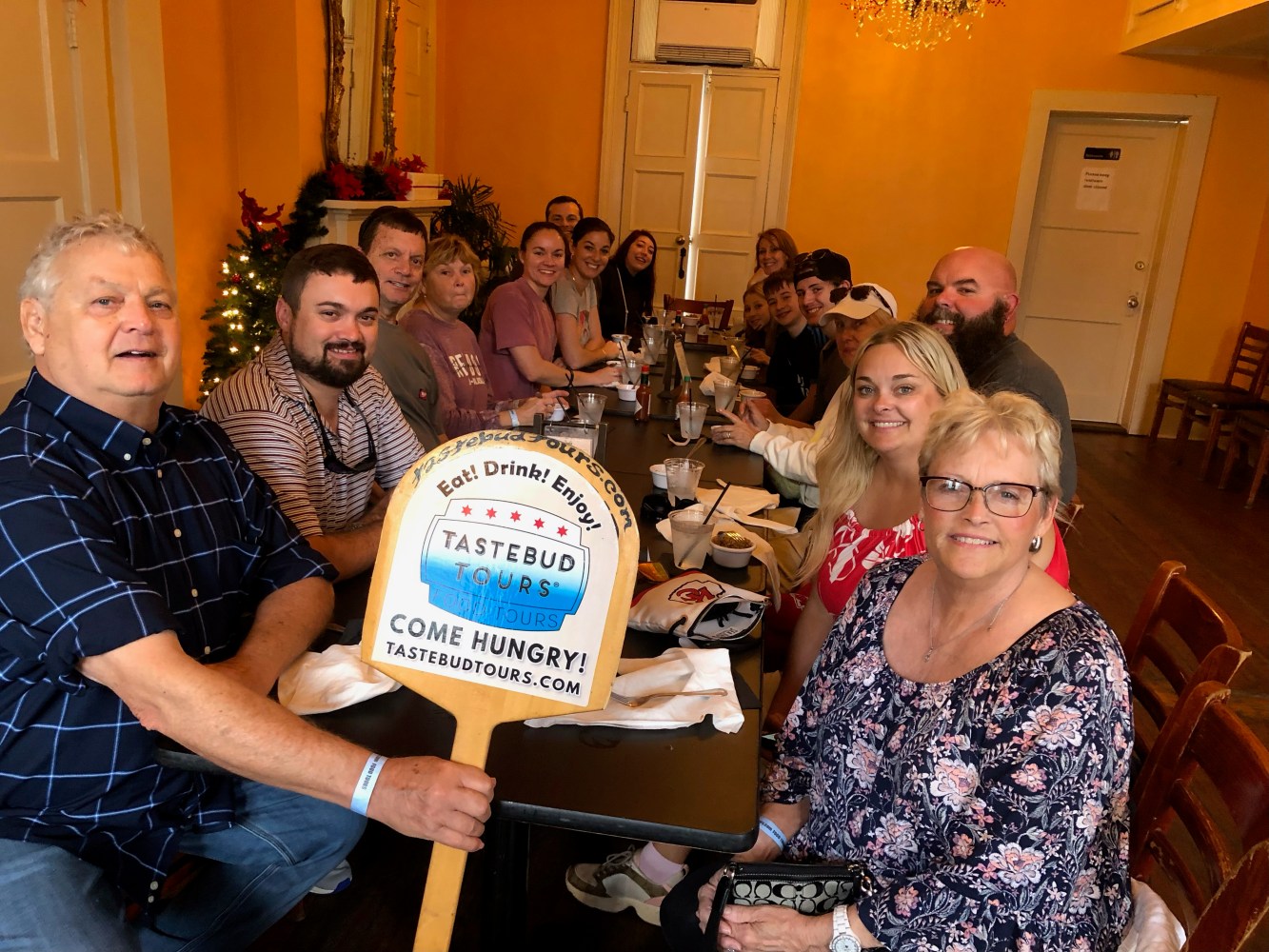 Tastebud Tours guests enjoying a group dining experience at a restaurant during a guided New Orleans food tour.